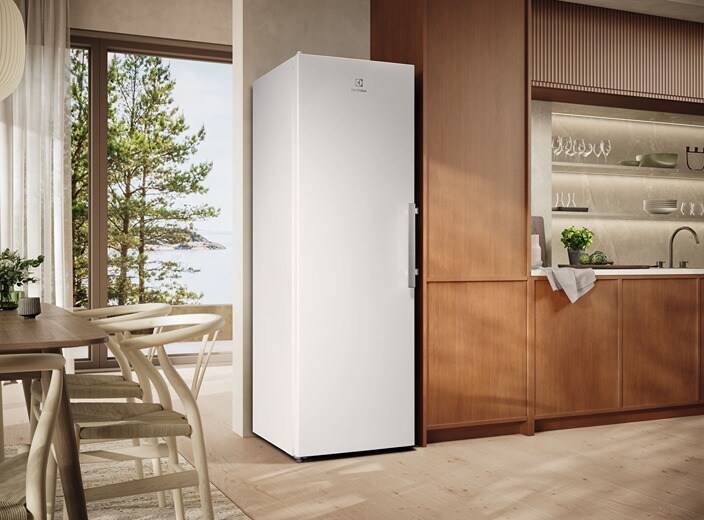 A white freezer is placed in a modern kitchen from Electrolux.