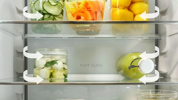 Different types of food are placed on the shelves in a fridge-freezer.