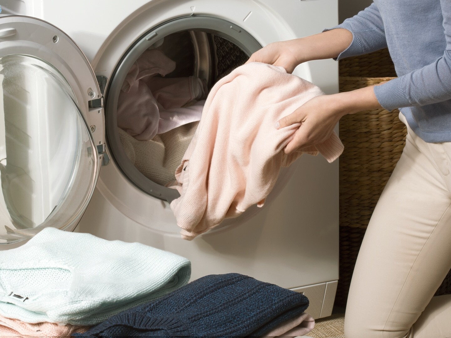 Putting in clothes in washer dryer