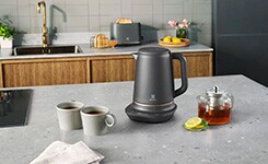 Kettle and two mugs on a table