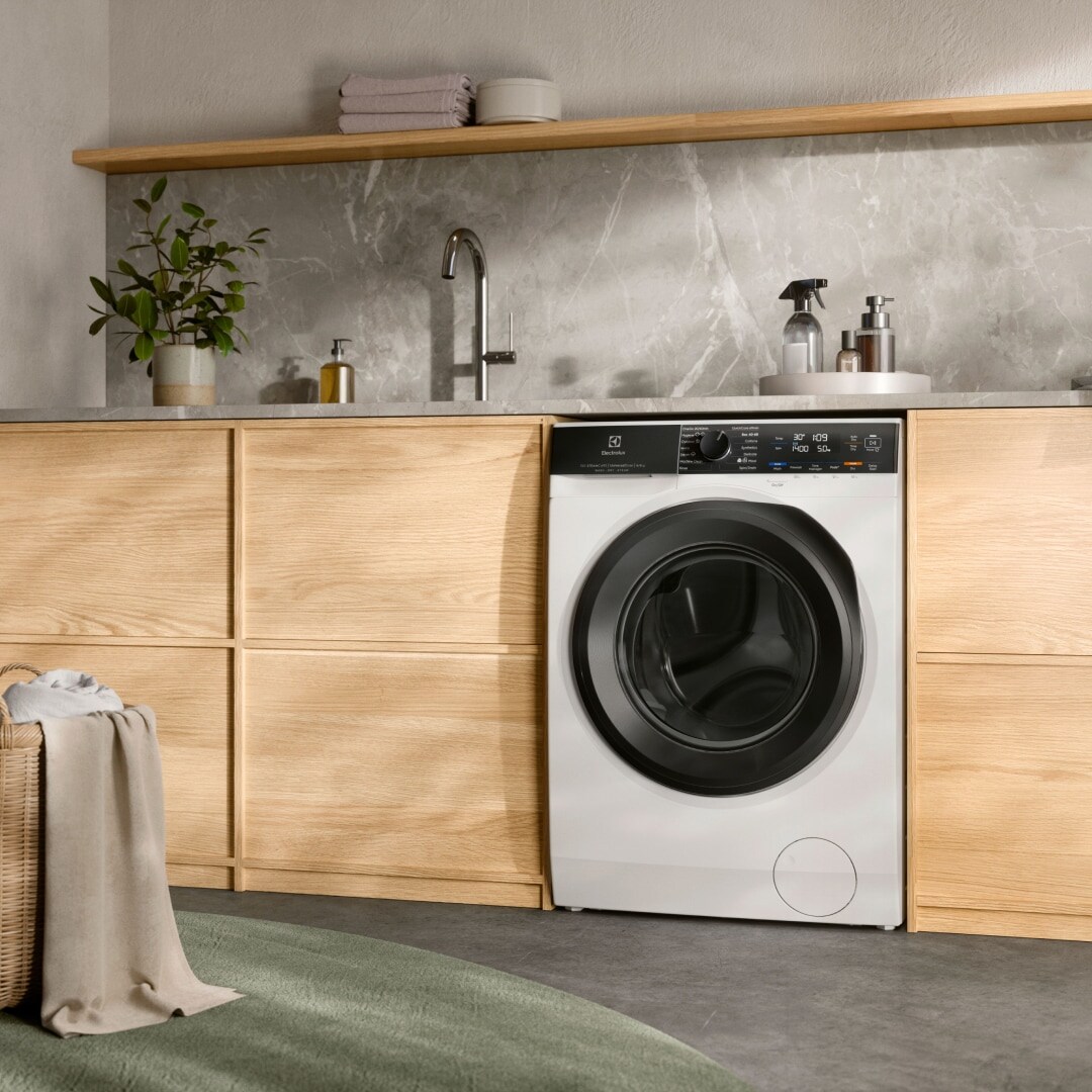 Electrolux washer dryer under a counter.